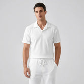 Model wearing white polo shirt and pant on white background with front view