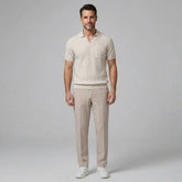Man wearing a beige waffle johnny collar polo shirt and slim fit tapered pants front view on plain background