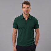 Man wearing a dark green stripe jacquard zip-up polo shirt front view on plain background