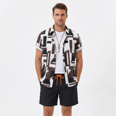 Man wearing a geometry colorblock print button up shirt and swim shorts front view on plain background