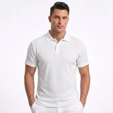 Man wearing MannerCo white jacquard knit polo shirt with button placket and classic collar, front view