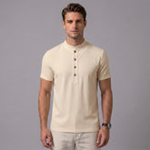 Man wearing a khaki linen jacquard short sleeve polo shirt front view on plain background