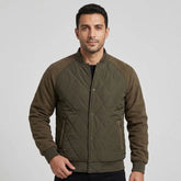 MannerCo men's olive quilted bomber jacket with baseball collar, front view on model