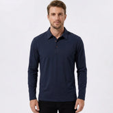 Man wearing a navy solid long sleeve cotton polo shirt front view on plain background