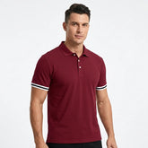 Man wearing MannerCo wine red polo shirt with striped cuffs and classic collar, front view