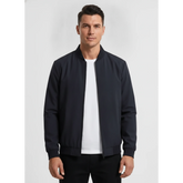 Man wearing MannerCo navy blue stand collar zip-up cardigan jacket, front view on plain background