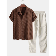 Coffee textured shirt and beige pants on a hanger against a white background