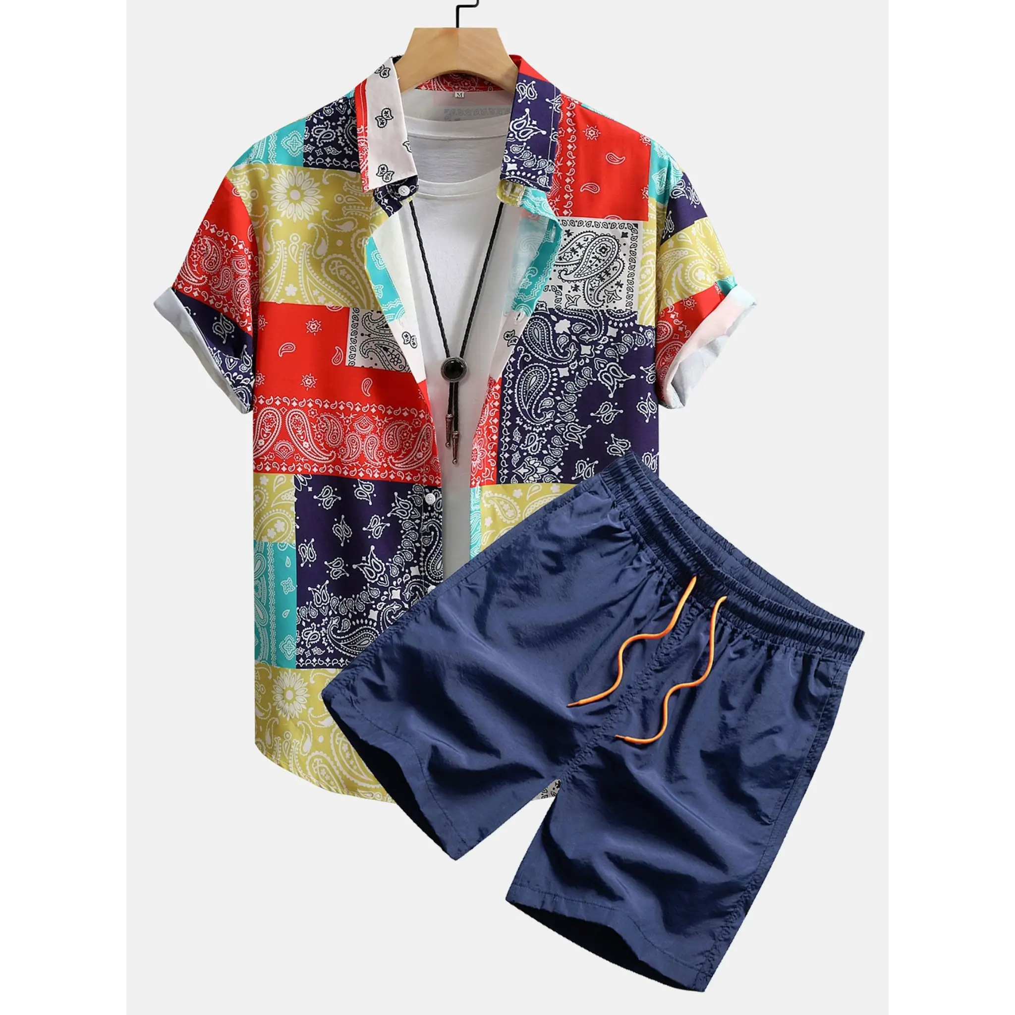 Colorful patterned shirt and navy shorts on a white background