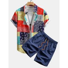 Colorful patterned shirt and navy shorts on a white background