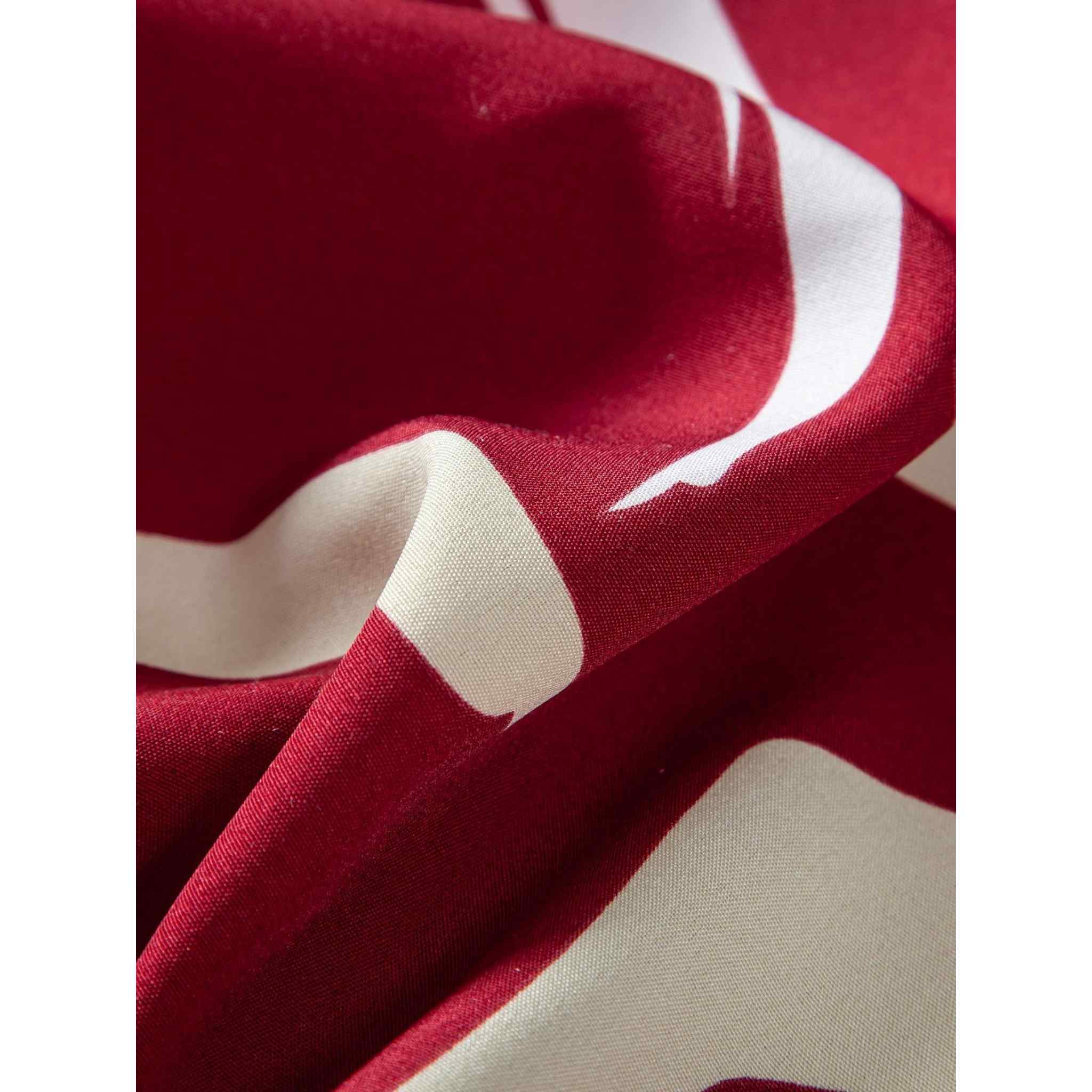 Abstract pattern fabric texture close-up in red and cream tones