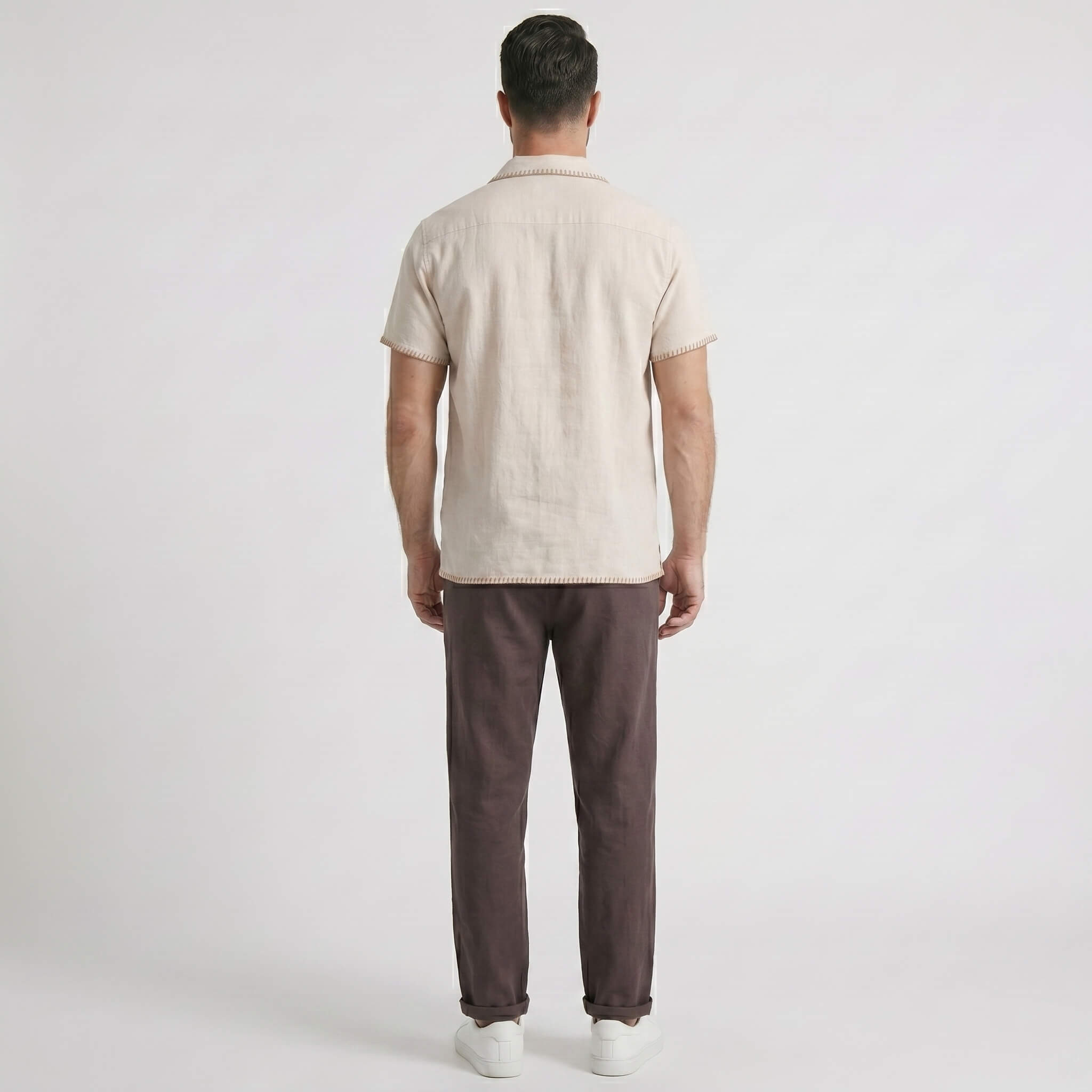Back view man wearing a beige shirt and coffee pants on a white background