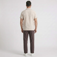 Back view man wearing a beige shirt and coffee pants on a white background