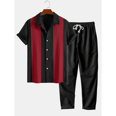 Black and red shirt with matching pants on a hanger against a white background