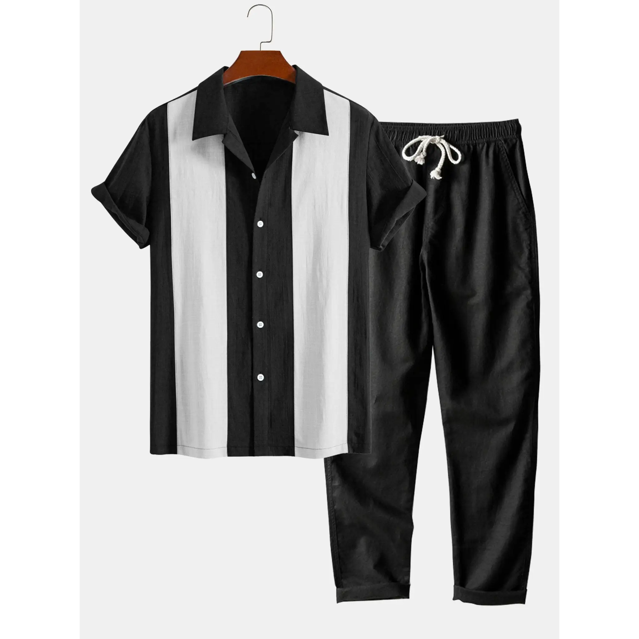 Black and white shirt with matching pants on a hanger against a white background