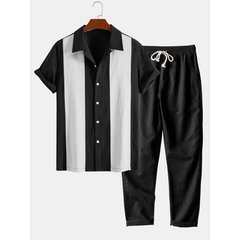Black and white shirt with matching pants on a hanger against a white background