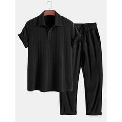 Black polo shirt and pants set on a white background