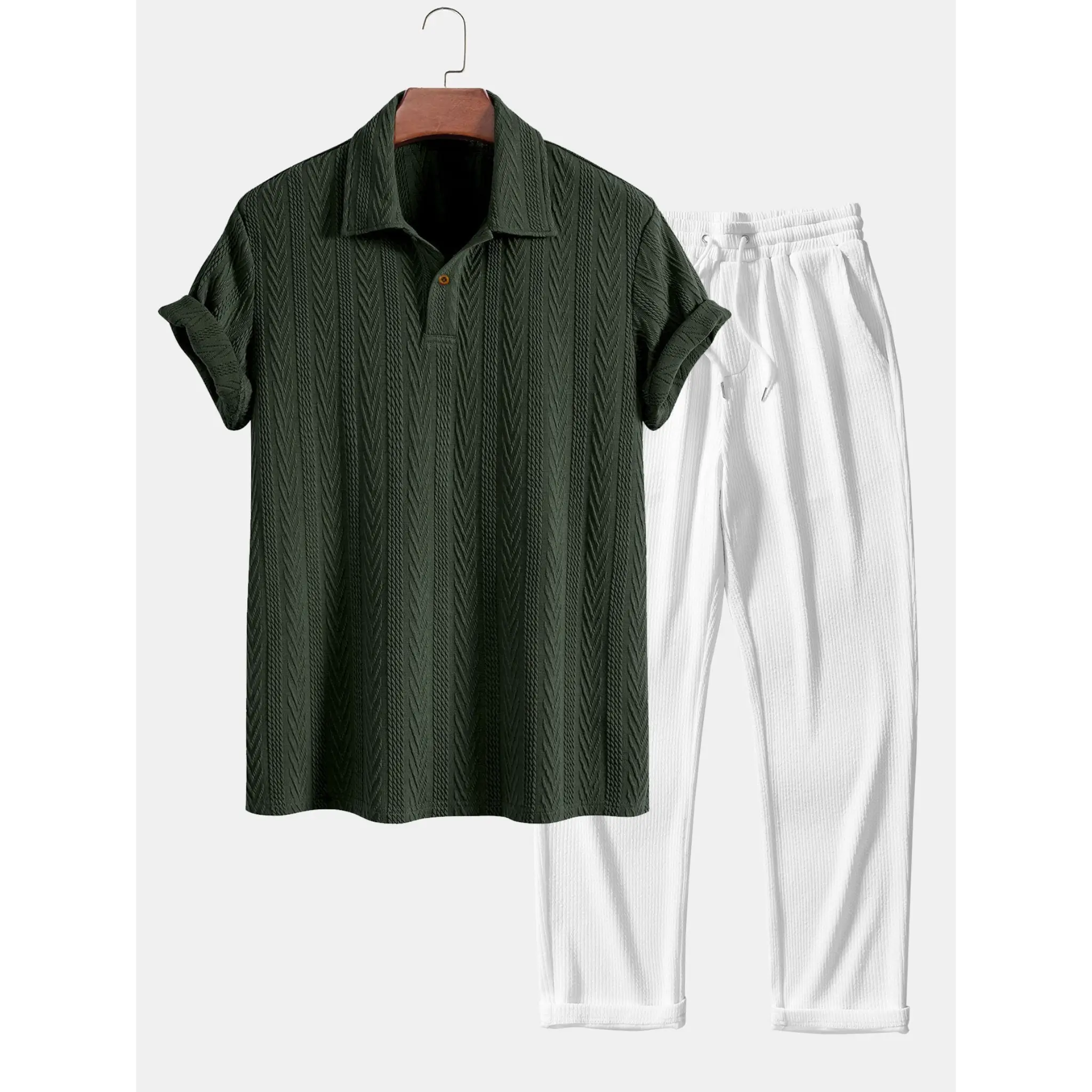 Black shirt and white pants on a hanger against a white background