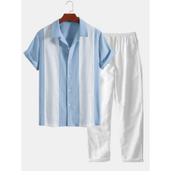 Blue and white striped shirt and pants set on a hanger against a white background