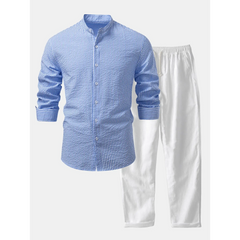Blue checkered shirt and white pants on a white background