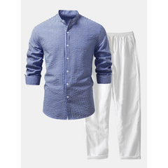 Blue checkered shirt and white pants on a white background