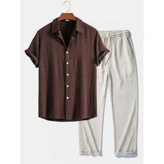 Brown shirt and white striped pants on a hanger against a white background