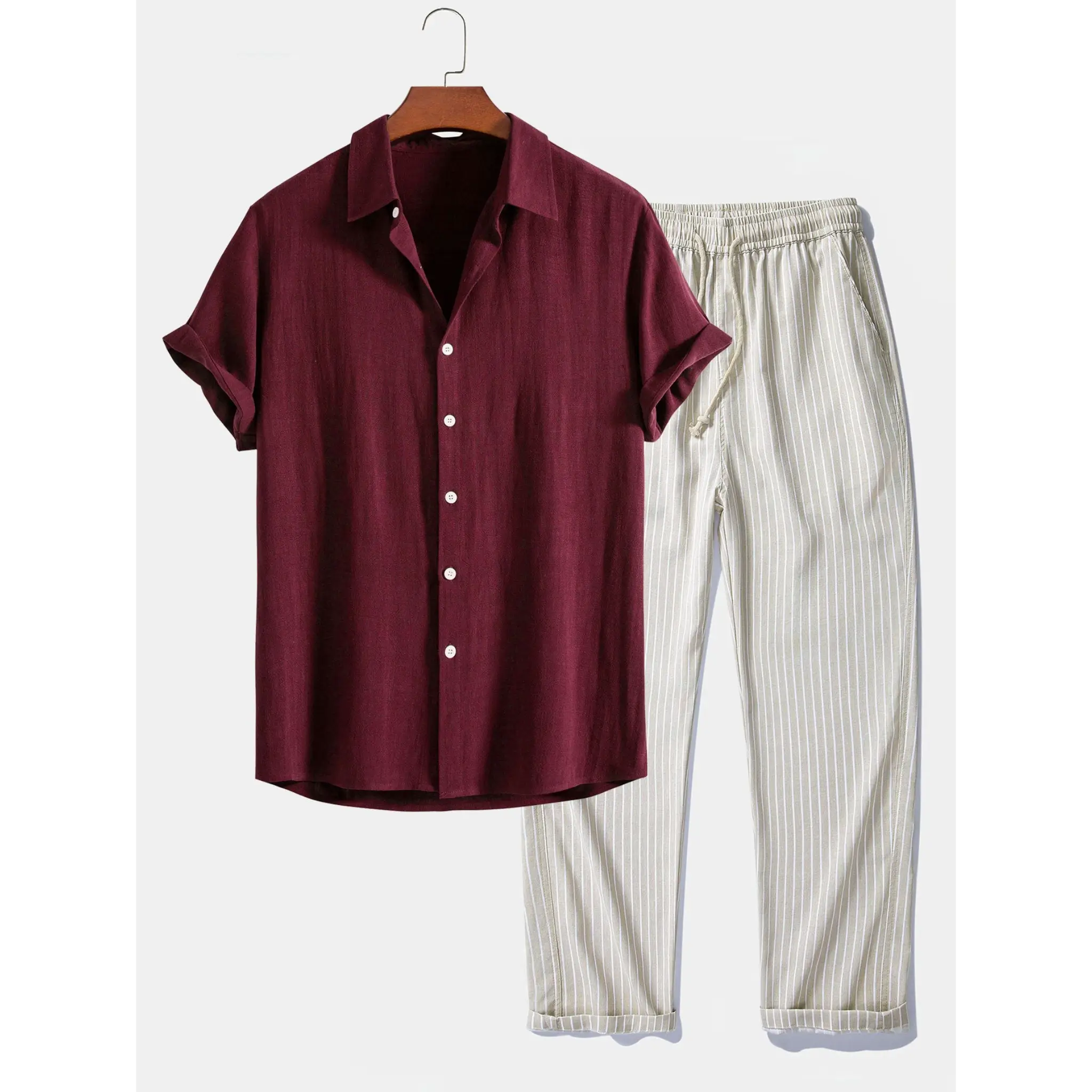 Brown shirt and white striped pants on a hanger against a white background