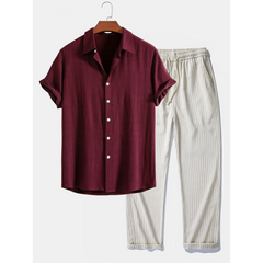Brown shirt and white striped pants on a hanger against a white background