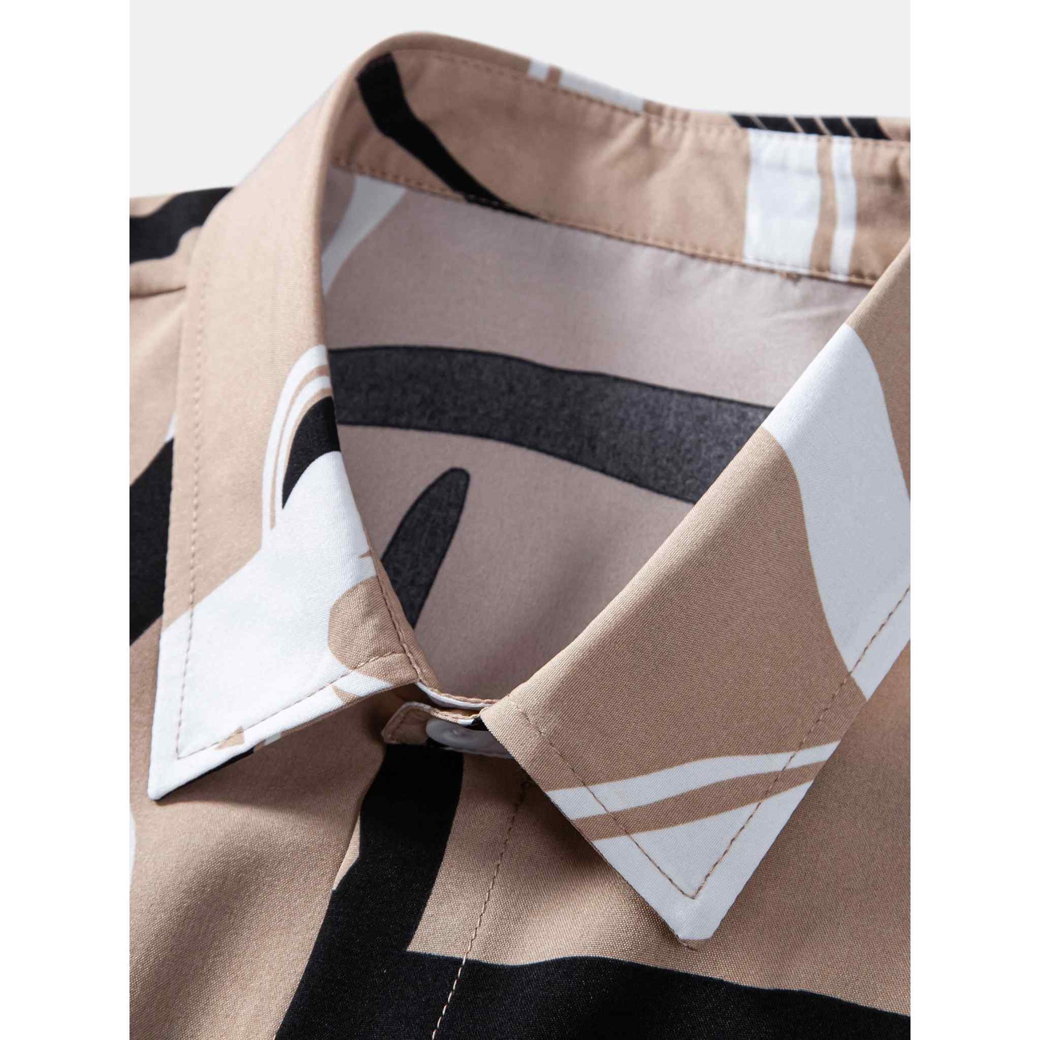 Close-up collar detail of beige abstract print button up shirt