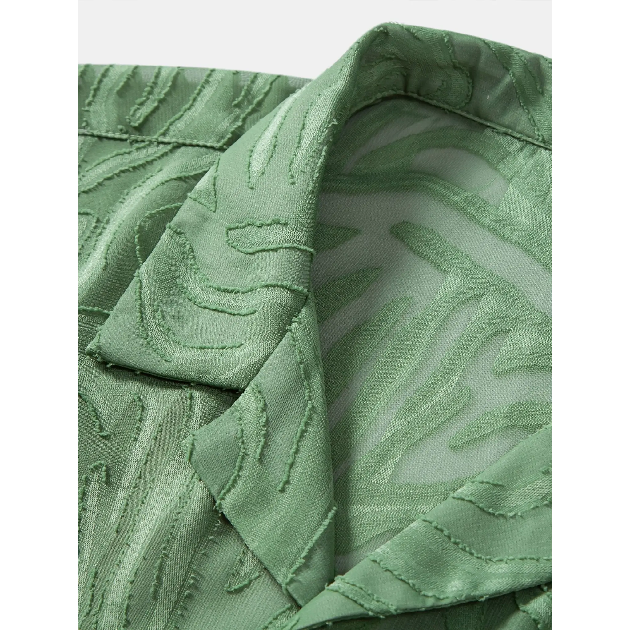 Close-up of green jacquard shirt fabric