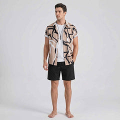 Front view of beige abstract print shirt with black swim shorts