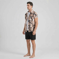 Full-body side angle of men’s beige resort wear outfit