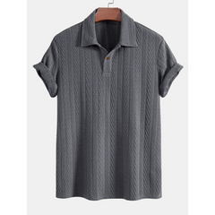 Gray textured polo shirt on a hanger with a white background