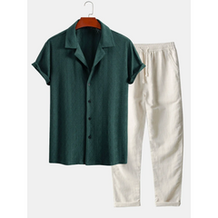 Green shirt and beige pants on a hanger against a white background