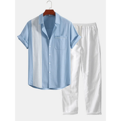 Light blue shirt and white pants on a hanger against a white background