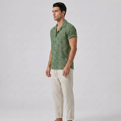 Man in green patterned Cuban shirt standing front view