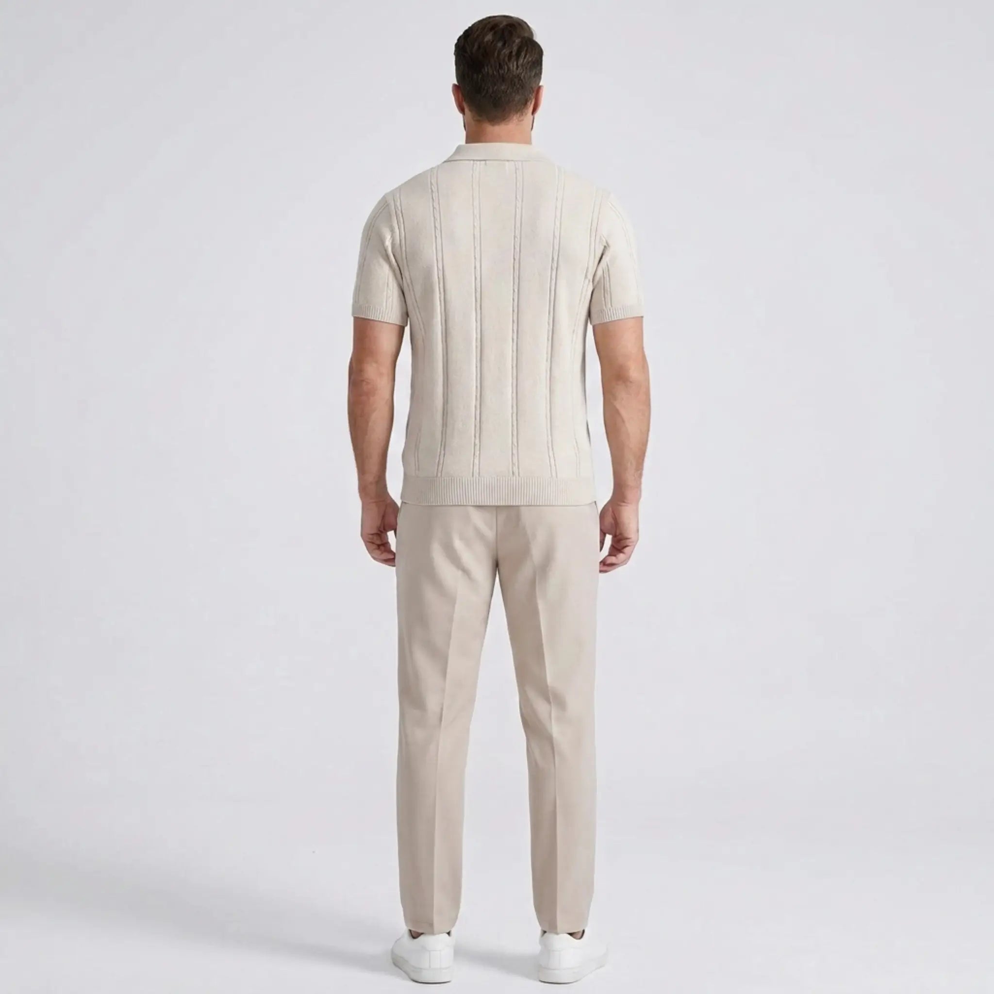 Man wearing a beige outfit on a white background