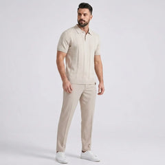 Man wearing a beige outfit with a white background