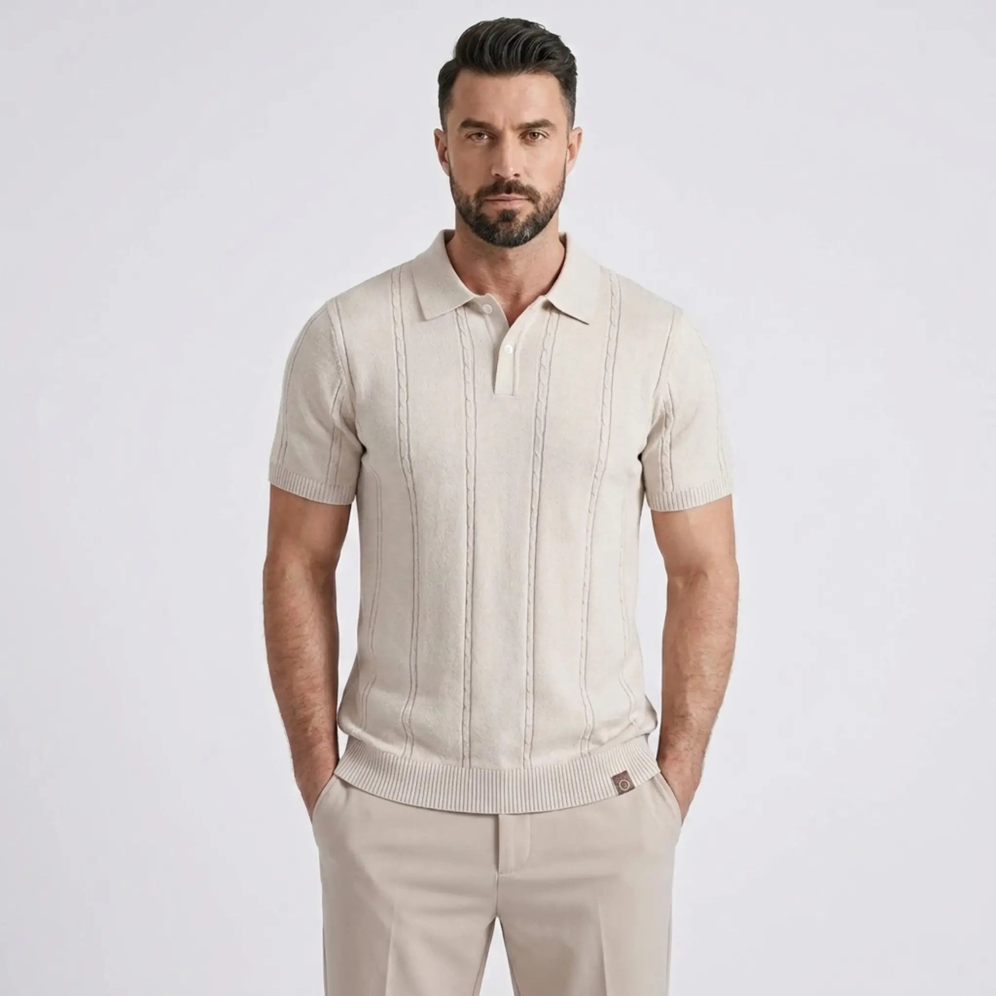 Man wearing a beige short-sleeve shirt and pants on a white background