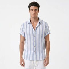 Man wearing a blue and white striped shirt on a light gray background