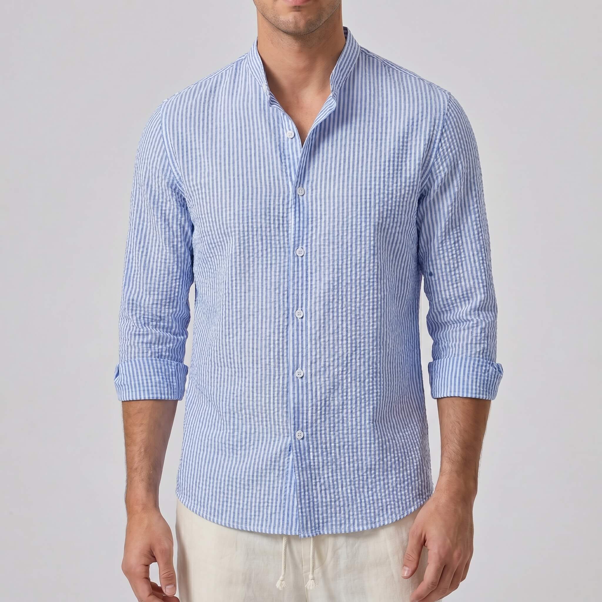 Man wearing a blue checkered shirt against a plain background