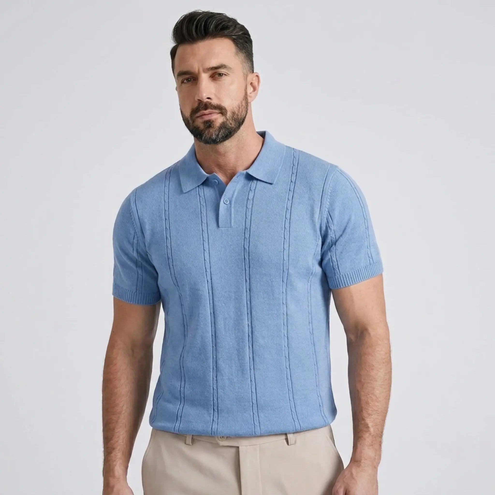 Man wearing a blue short-sleeve shirt against a light gray background