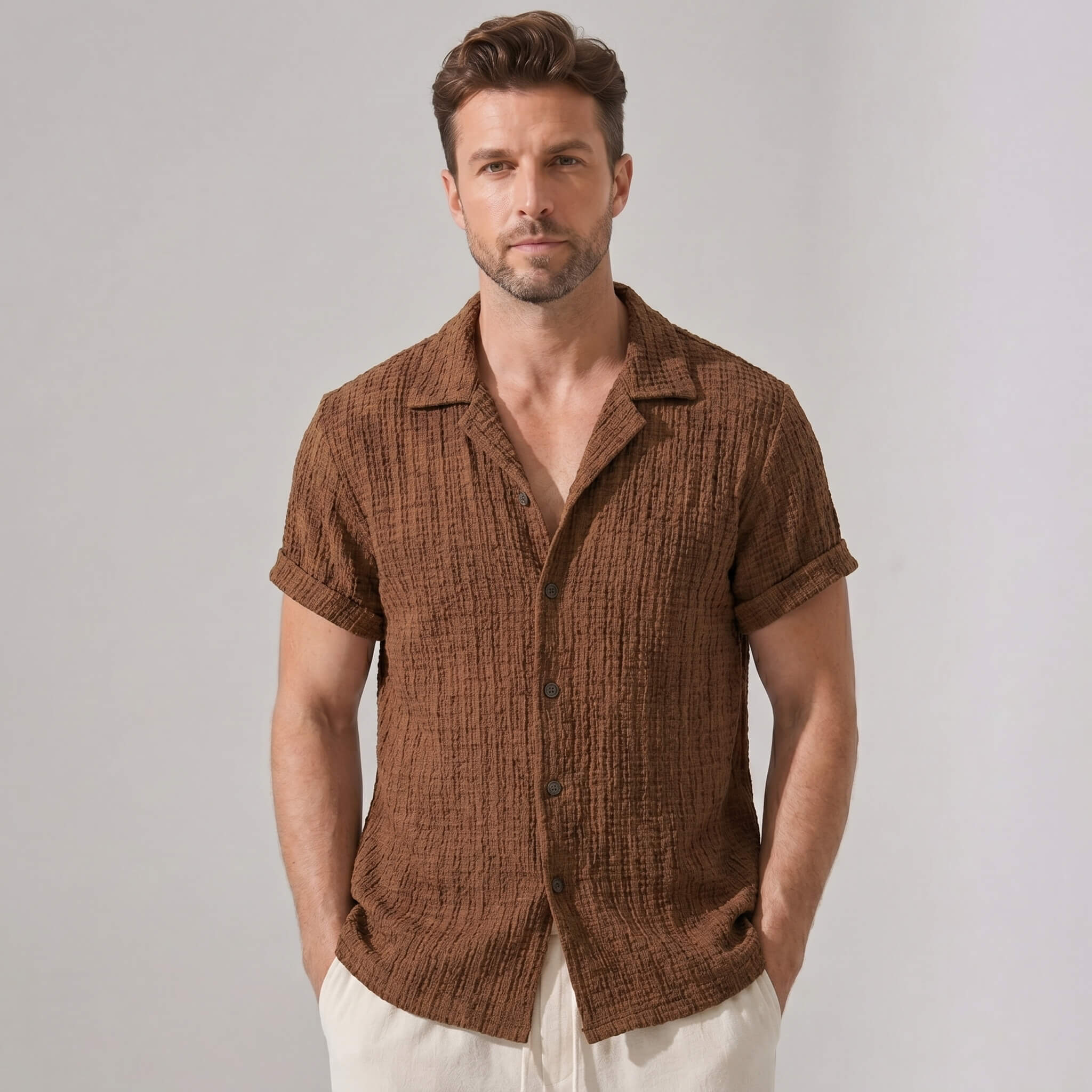 Man wearing a brown textured shirt against a plain background
