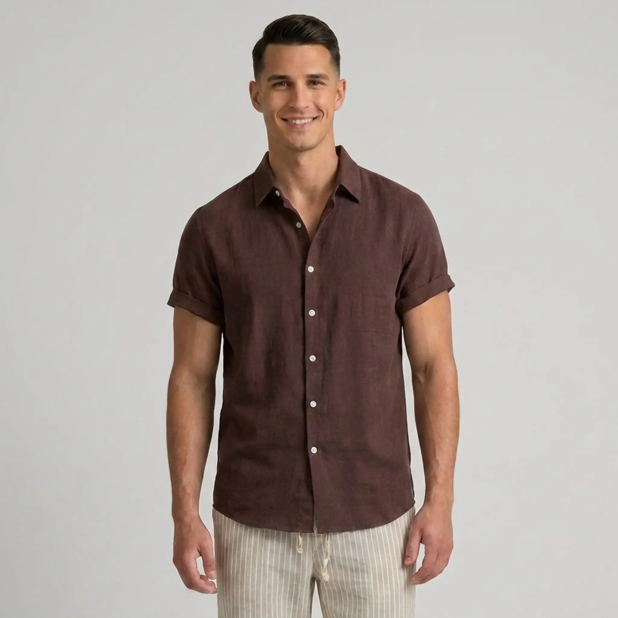 Man wearing a coffee short-sleeve shirt on a gray background