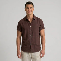 Man wearing a coffee short-sleeve shirt on a gray background