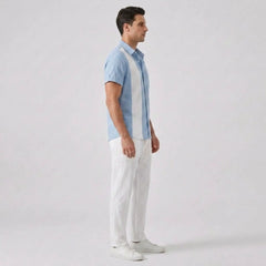 Man wearing a light blue and white striped shirt with white pants on a plain background
