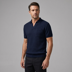 Man wearing a navy blue textured polo shirt against a gray background