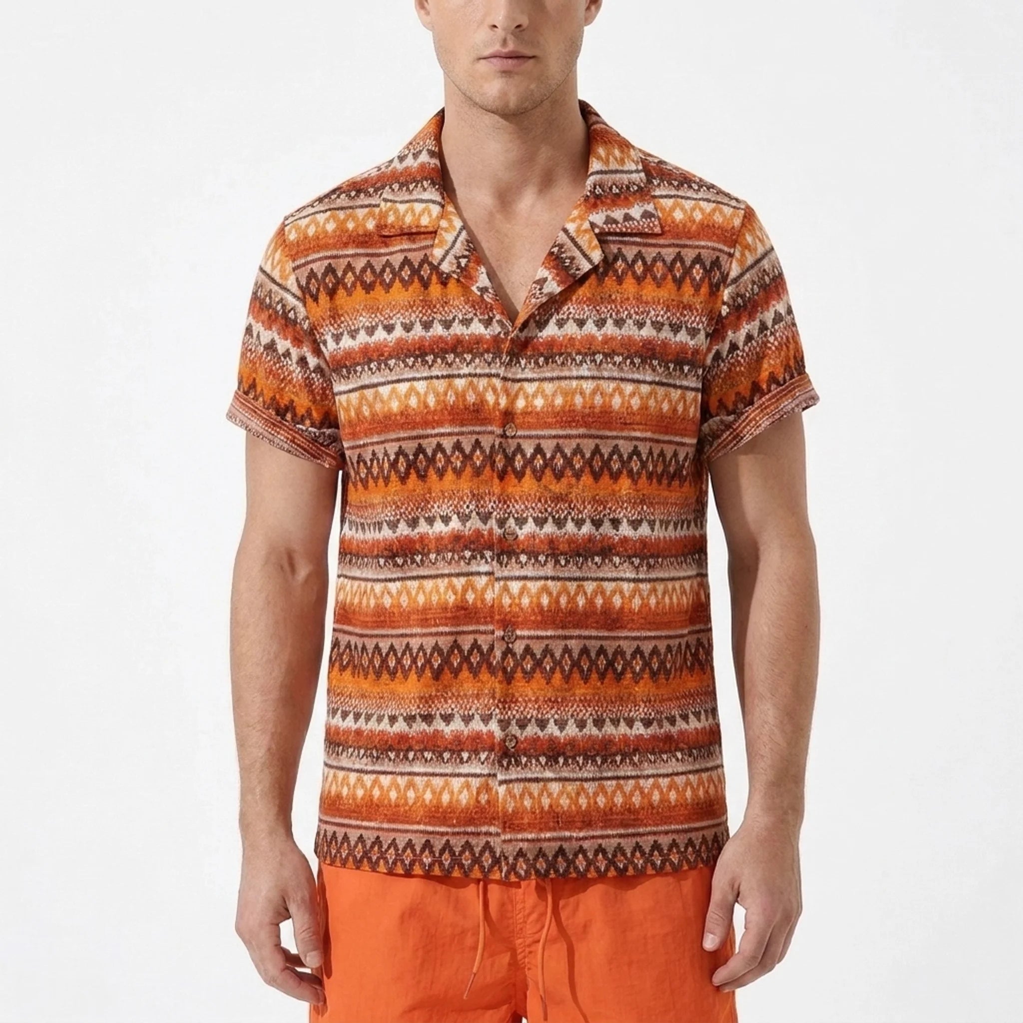 Man wearing a patterned orange shirt and matching shorts on a white background