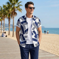 Man wearing a patterned shirt and sunglasses on a beach boardwalk