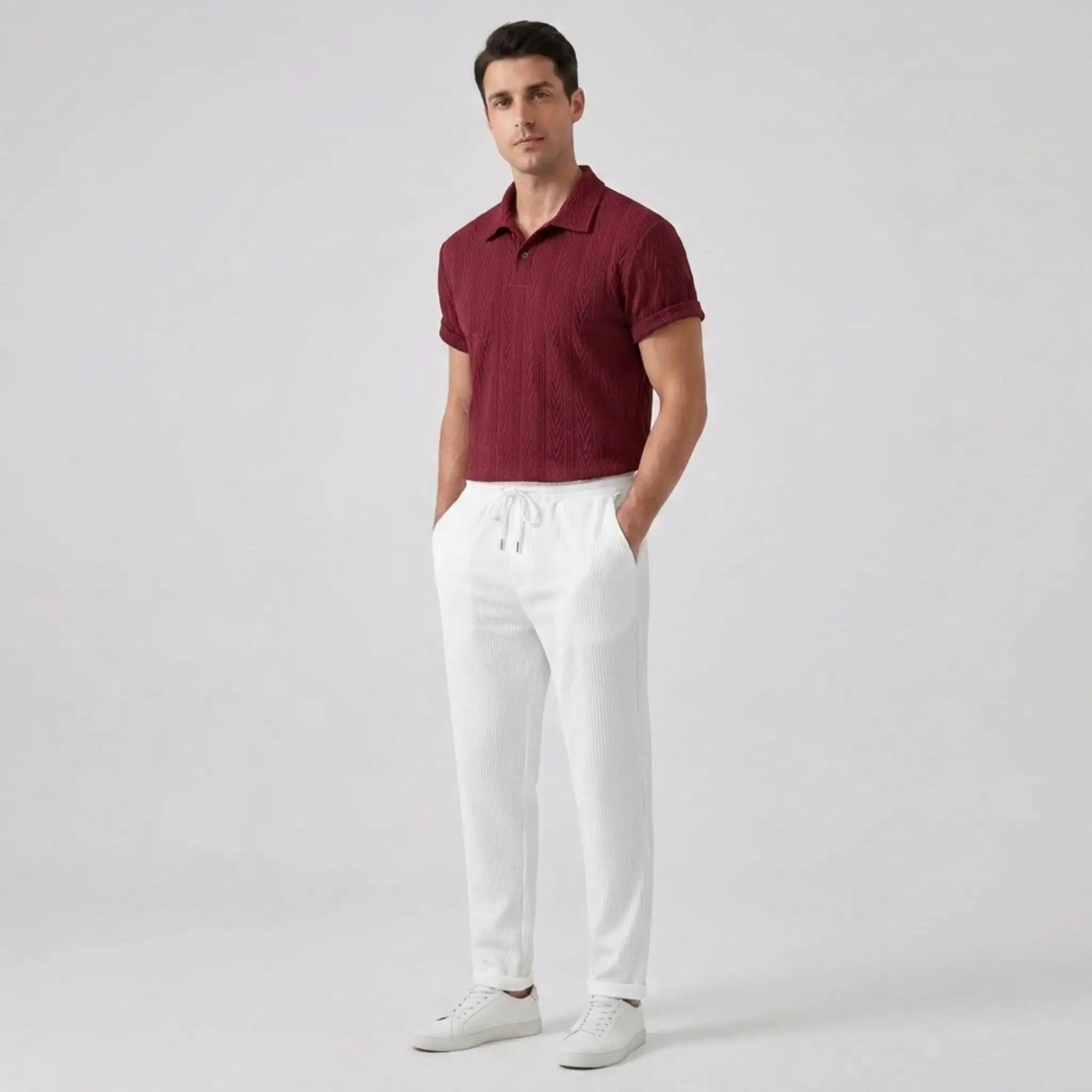 Man wearing a red polo shirt and white pants side view on a light gray background