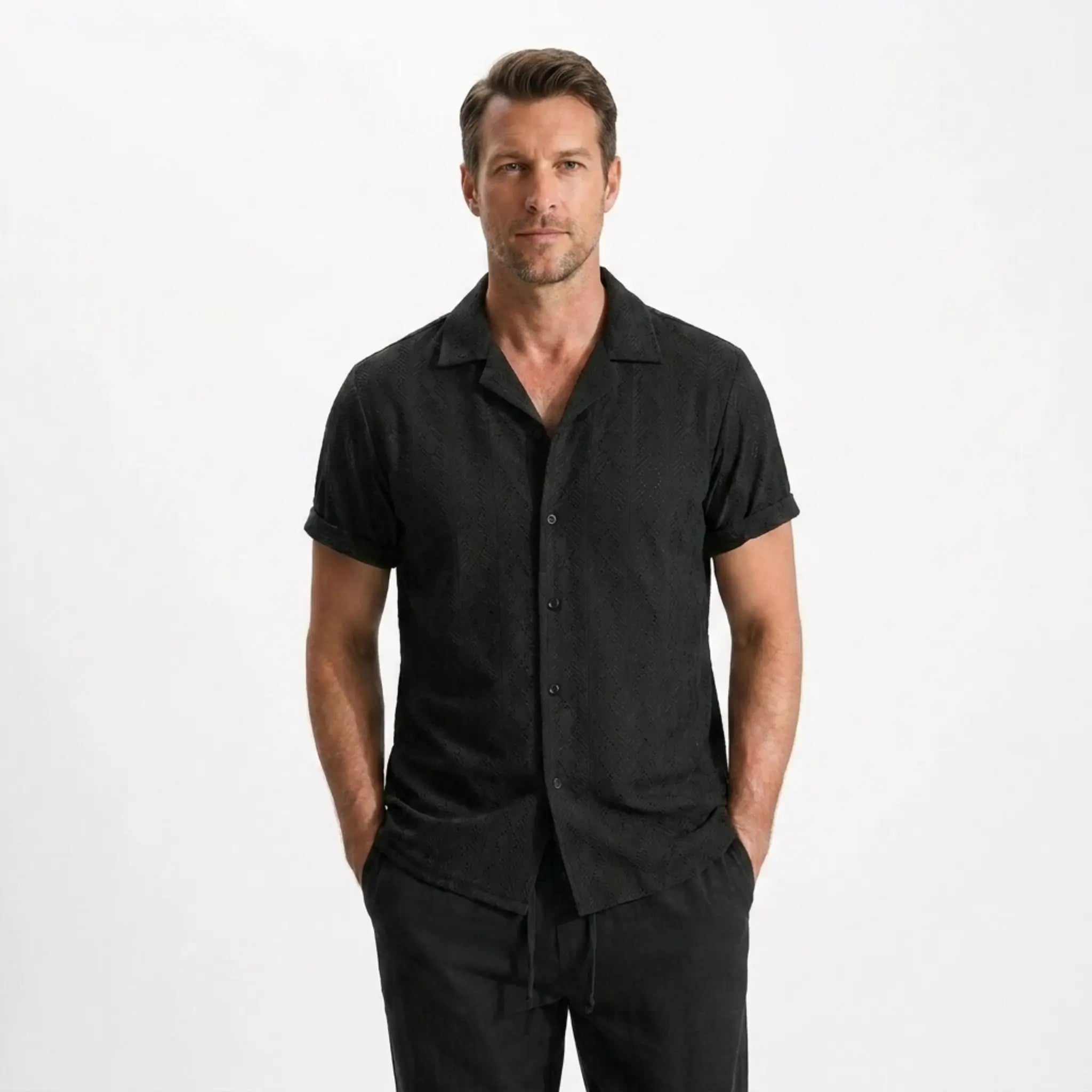 Man wearing a striped shirt and black pants on a white background
